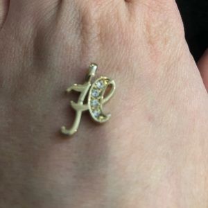 H charm.  Gold look and stones